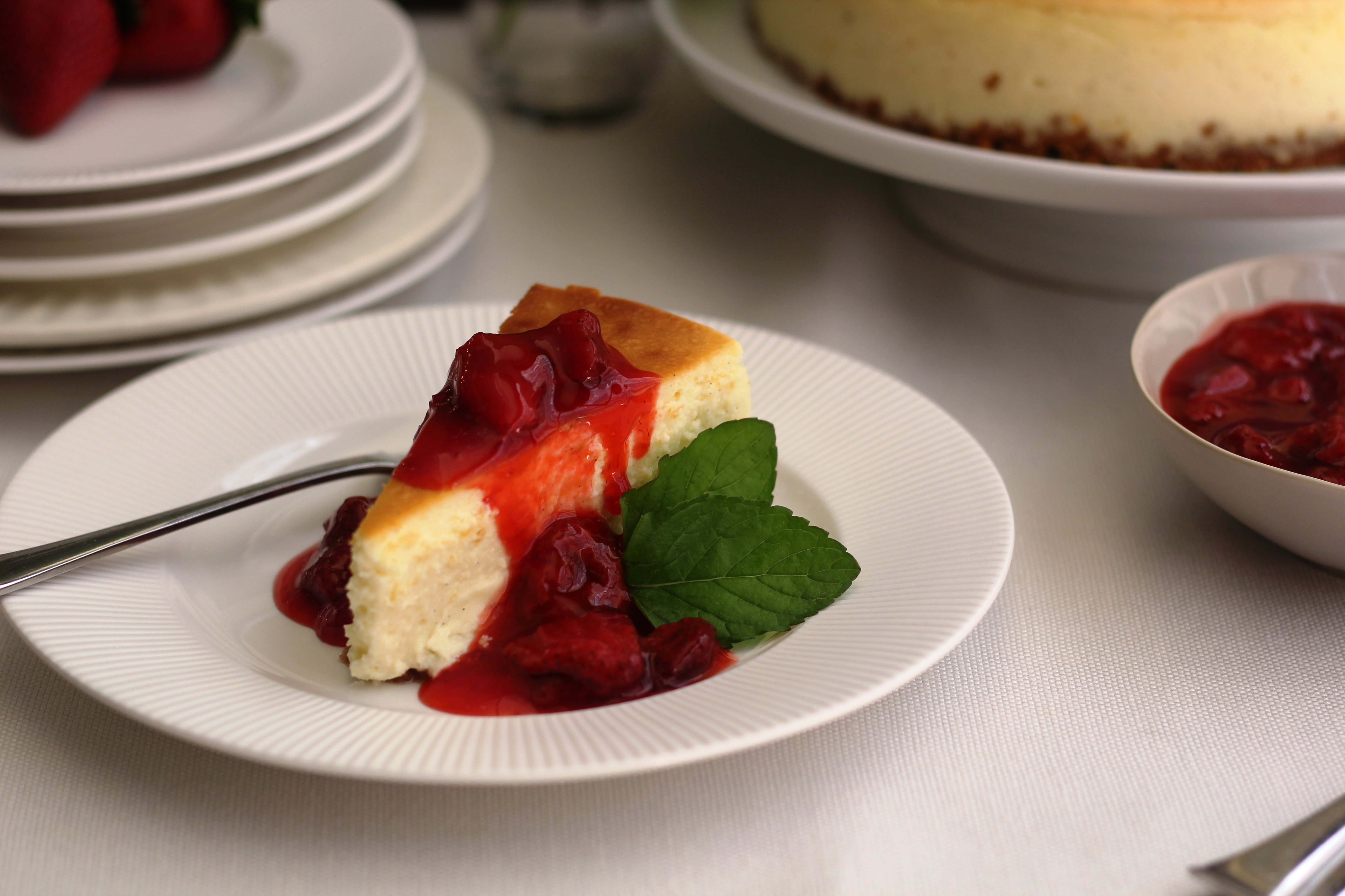 Simply Delicious New York Style Cheesecake With Strawberry Sauce